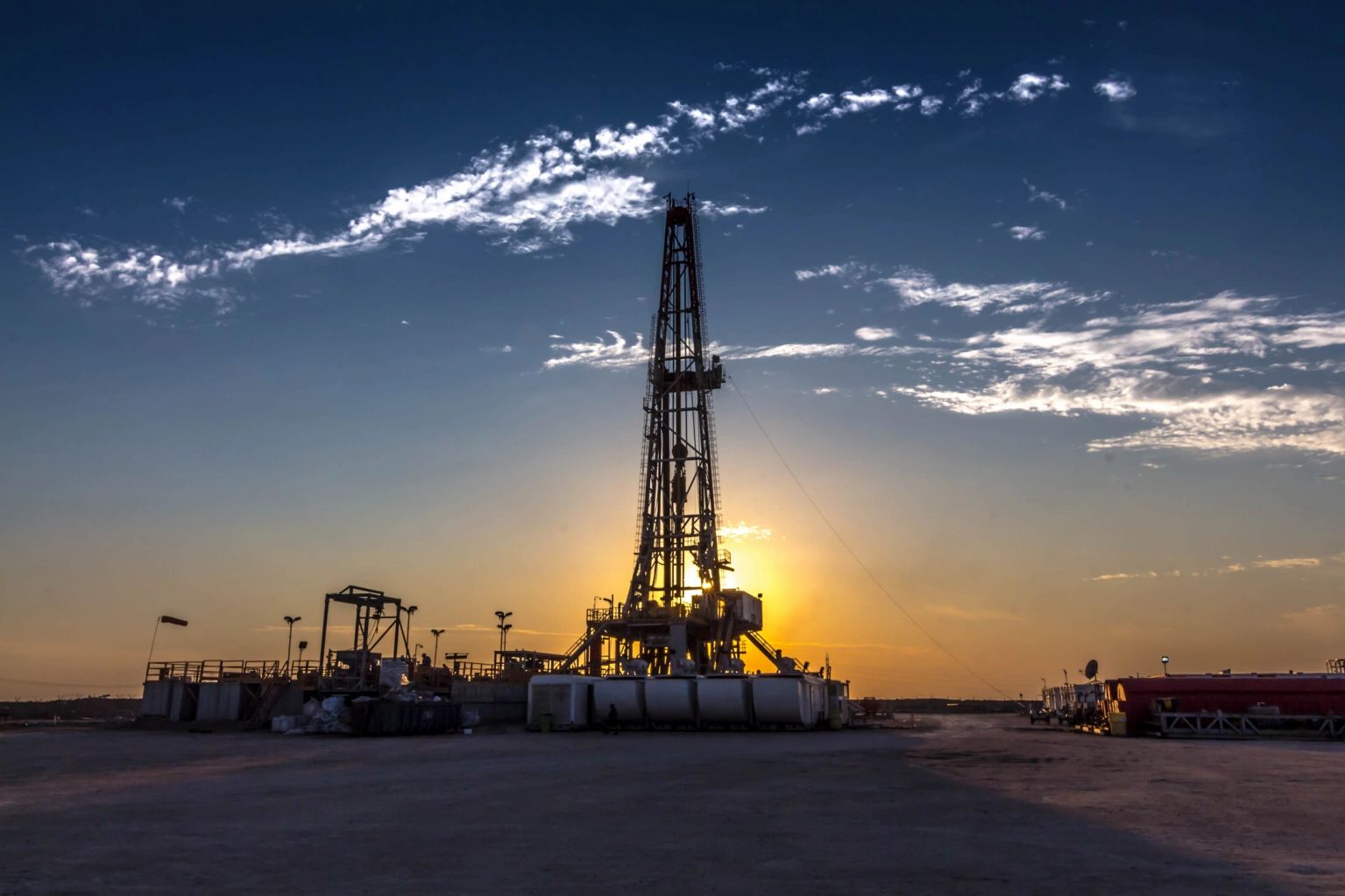 Oil drilling rig at sunset